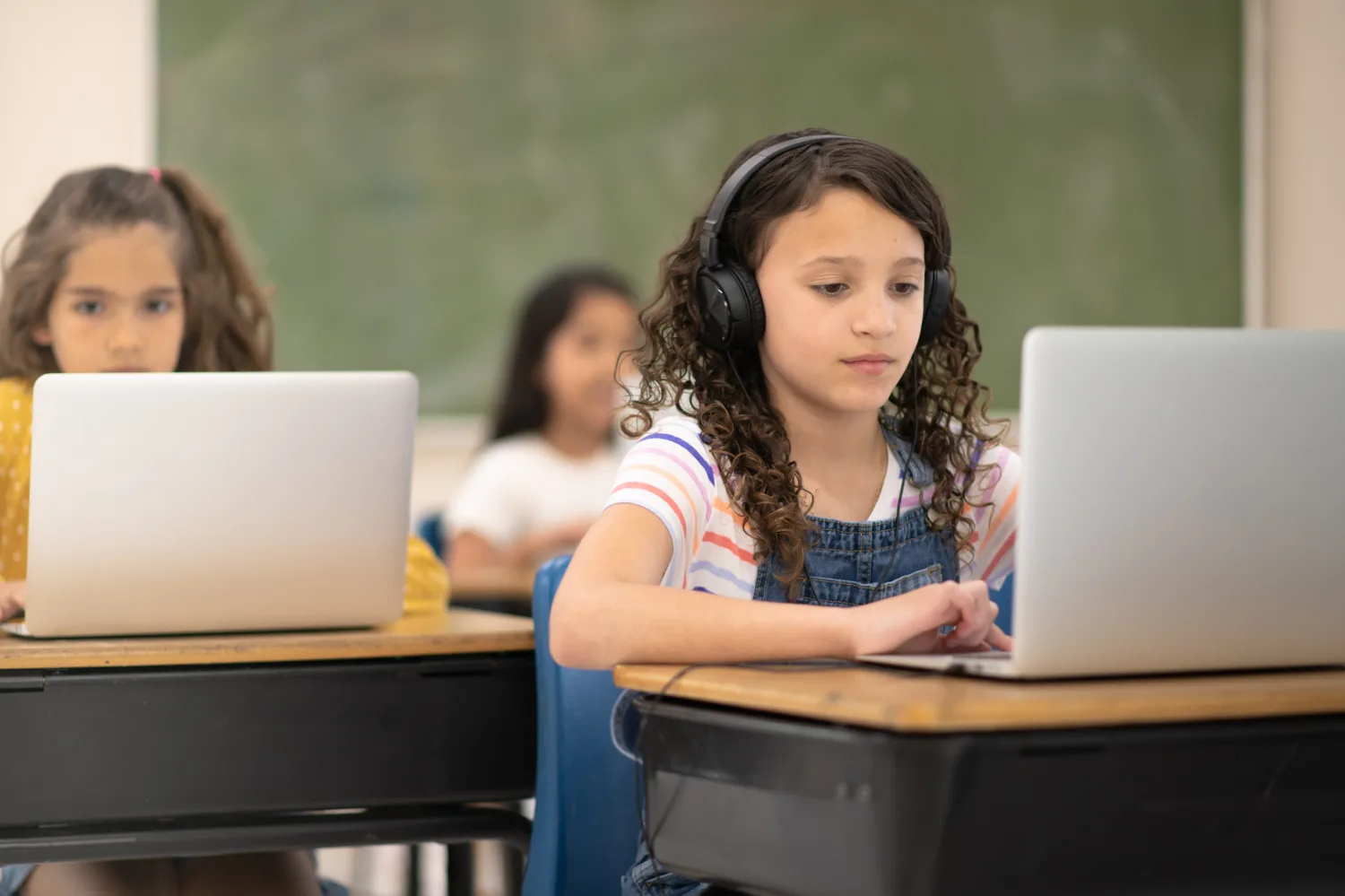 Student wearing headphones taking an online course on a laptop